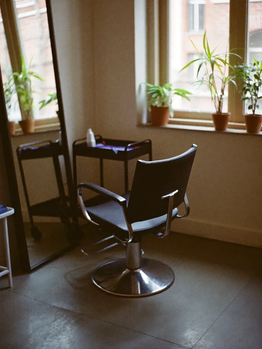 A styling chair and mirror in a quiet corner of the salon
